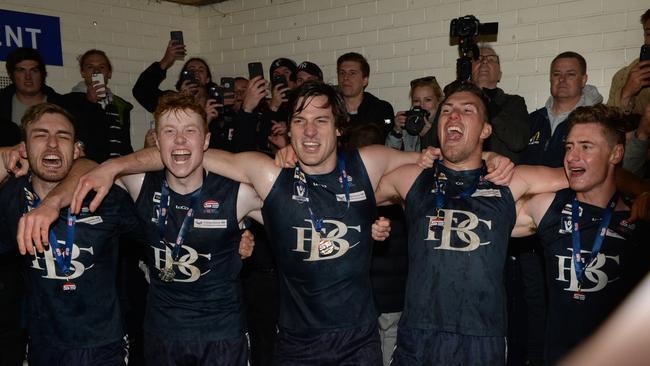 Berwick players belt out the club song after their grand final win. Picture: Chris Eastman