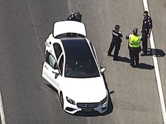 Police beside the seized stolen vehicle following the chase. Picture: 7News