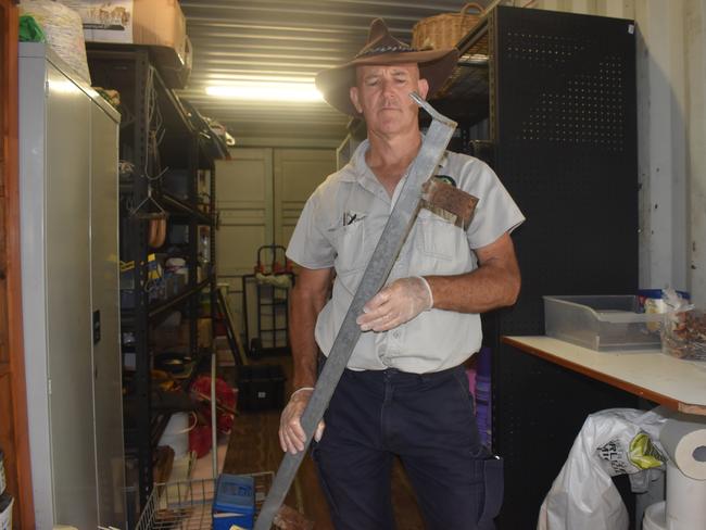 Mike Johnson from Landcare shows the metal bar thieves used to break in to the nursery.