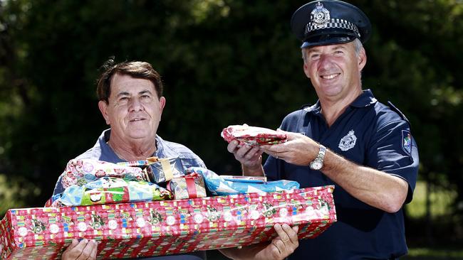 Larry Williamson with Senior Sergeant Murray Underwood from the Runaway Bay police station after the presents and his car were found by police. Picture: Jerad Williams