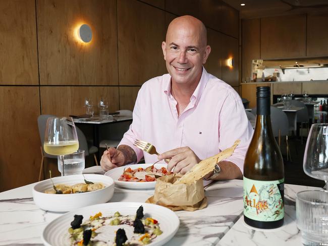 A new restaurant and adjoining bar have opened in the Drift apartment building at Palm Cove, opposite Miguel's tapas restaurant. Ignis restaurant owner Michael Kohn with the vitello tonnato, the hand made butter sage pasta and the octopus carpaccio. Picture: Brendan Radke