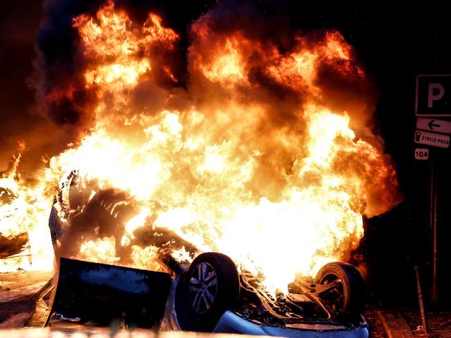 A car burns on the sideline of a demonstration by Yellow vests (Gilets jaunes) against rising oil prices and living costs, on December 1, 2018 in Paris. (Photo by Abdulmonam EASSA / AFP)