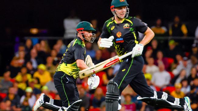 Aaron Finch and Cameron Green run between the wickets during the opening cricket match of the Twenty20 series between Australia and West Indies.