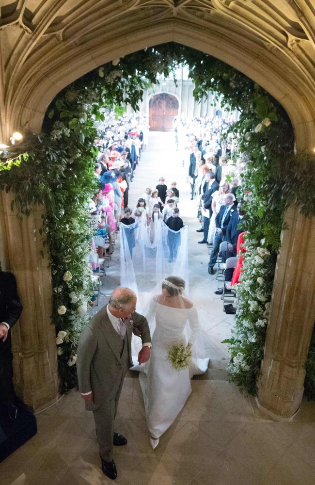 Meghan Markle walks down the aisle with Prince Charles. Picture: AFP