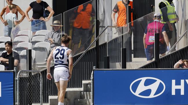 A dejected Cameron Guthrie heads for the rooms at Ikon Park after injuring his groin in the opening minute of Geelong’s pre-season clash against Carlton. Picture: Michael Klein