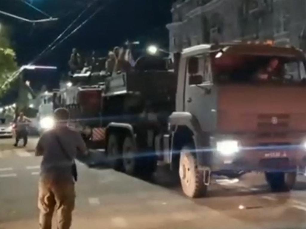 A Wagner Group military vehicle of waiting for Yevgeny Prigozhin to leave the headquarters of the Russian southern military district in the city of Rostov-on-Don as pedestrians film and salute him. Picture: AFP