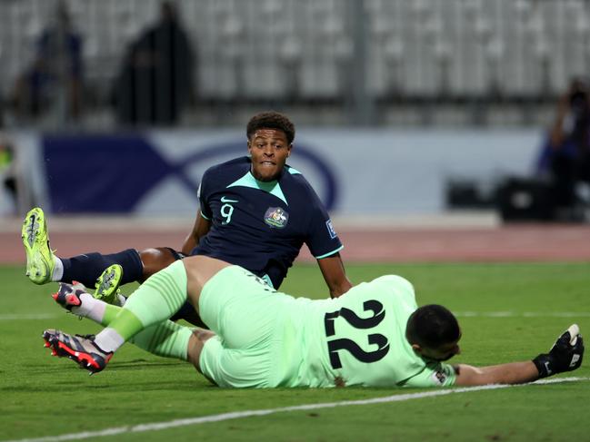 MANAMA, BAHRAIN - NOVEMBER 19: Kusini Yengi of Australia scores his team's first goal past Ebrahim Lutfalla of Bahrain during the FIFA World Cup Asian 3rd Qualifier Group C match between Bahrain and Australia on November 19, 2024 in Manama, Bahrain. (Photo by Christopher Pike/Getty Images)