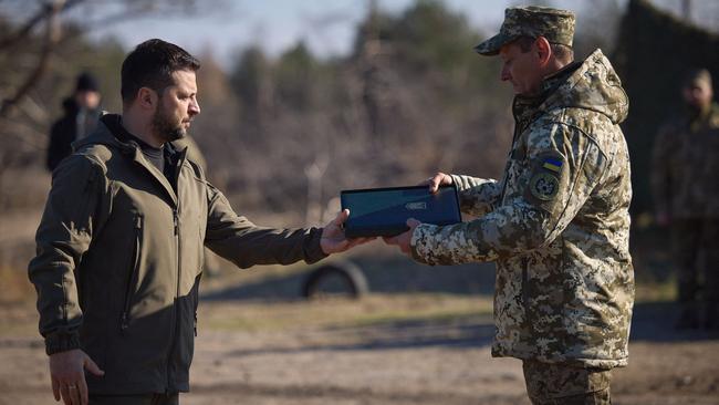 Ukraine's President Volodymyr Zelensky awarding a serviceman during a visit to a training centre to mark the "Missile Forces and Artillery and the Engineering Troops" Day at an undisclosed location in Ukraine, amid the Russian invasion. Picture: Handout/Ukrainian Presidential Press Service/AFP