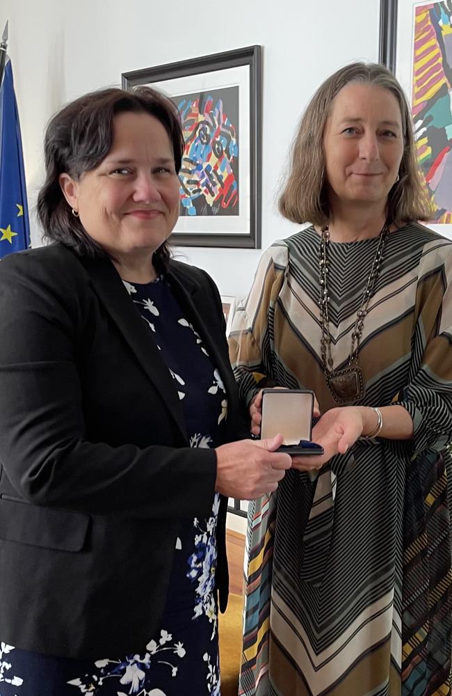 Ingham woman Veronica Green has spent years chasing the history of her Dutch family in Indonesia in World War II. Veronica Green with presentation ceremony with Dutch Ambassador Ardi Stoios-Braken. Picture: Supplied