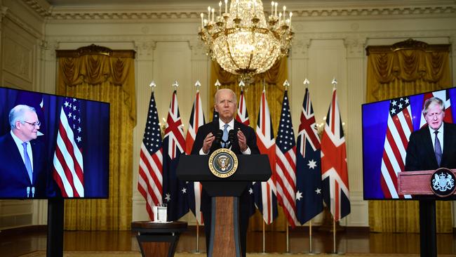 Joe Biden at the White House in a video conference with Boris Johnson, right, and Scott Morrison on Thursday. Picture: AFP