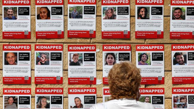 A woman looks at posters showing the pictures of hostages held by Palestinian militants since the October 7 attack. Picture: AFP