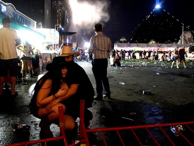 People take cover after a man opened fire, killing dozens and injuring hundreds. Picture: Getty