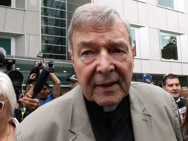 (FILES) In this file photo taken on February 26, 2019 Cardinal George Pell (C) leaves the County Court of Victoria court after prosecutors decided not to proceed with a second trial on alleged historical child sexual offences in Melbourne. - Disgraced Australian Cardinal Pell was sentenced to six years in jail for child sex crimes in a Melbourne court on March 13, 2019, with a non-parole period of three years and eight months. (Photo by Asanka Brendon Ratnayake / AFP)