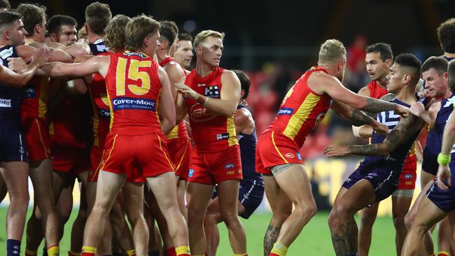 GOLD COAST, AUSTRALIA - JUNE 27: Players grapple during the round 4 AFL match between the Gold Coast Suns and Fremantle Dockers at Metricon Stadium on June 27, 2020 in Gold Coast, Australia. (Photo by Chris Hyde/Getty Images)