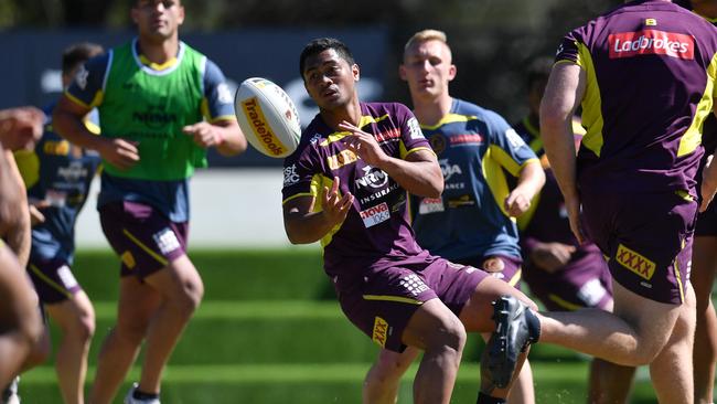 Anthony Milford (centre) in action during a Brisbane Broncos training session on Monday before being struck down by the virus. Picture: AAP