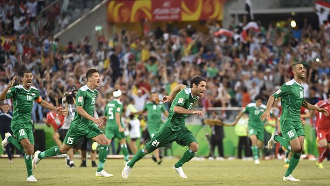 Iraq celebrate the moment they beat Iran on penalties.