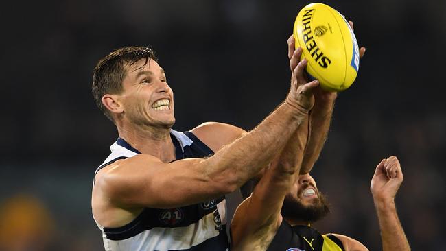 Tom Hawkins flies above Shane Edwards to mark during Geelong’s win over Richmond. Picture: AAP Image/Julian Smith.