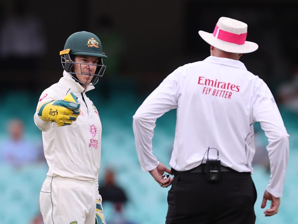 Tim Paine speaks with an umpire.