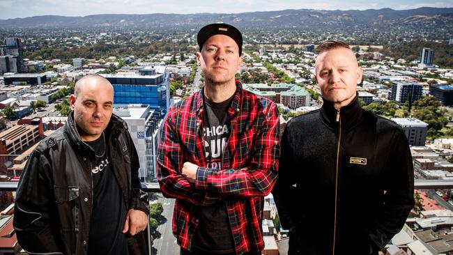 The Hilltop Hoods – Barry Francis (DJ Debris), Matt Lambert (Suffa) and Dan Smith (Pressure) above the rooftops of Adelaide. Picture: Matt Turner