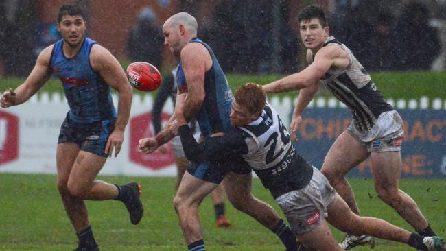 Port Adelaide’s Willem Drew tackles Sturt captain Zane Kirkwood. Picture: Brenton Edwards/AAP