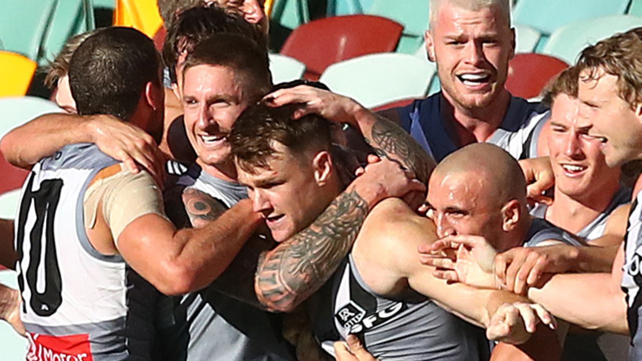The Power celebrate the winning goal with goalkicker Robbie Gray. Picture: Jono Searle