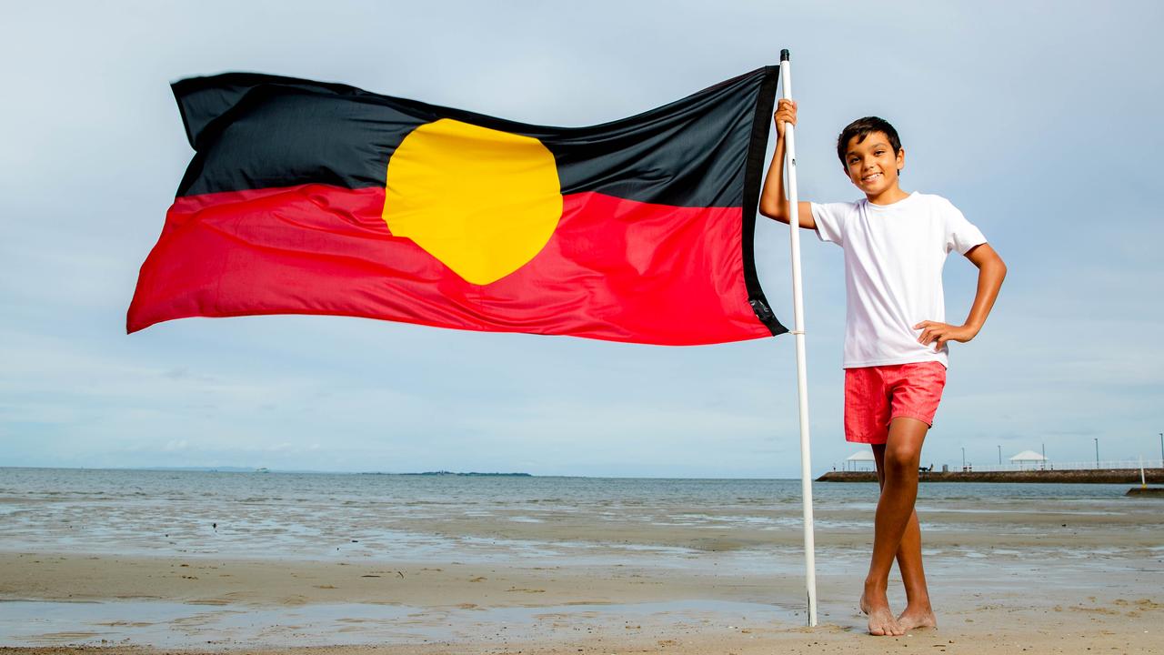Jamarley Edey, 12, from the Brisbane suburb of Wynnum, proudly flies the Aboriginal flag. Picture: Richard Walker