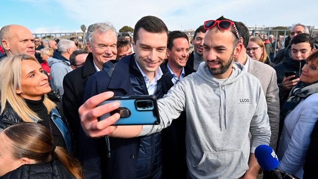 Jordan Bardella takes a selfie with a supporter as he attends a bullfighting event southern France. Picture: AFP