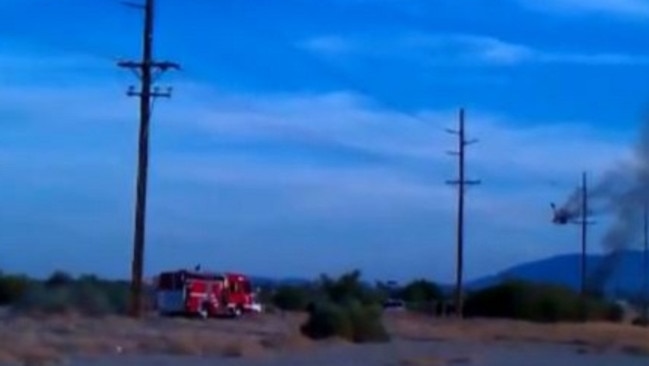 A fire engine arrives as a hot air balloon burns in Lockhart, Texas.