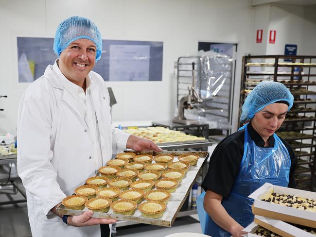 The Daily Telegraph 4.9.2024 Madhouse Bakehouse founder Ross Galettis, pictured at his Chullora business with Pastry Chef Anna Suleiman (right). Each week they have to deal with up to a pallet full of food waste, which either goes to the skip bin or food banks.. Picture Rohan Kelly