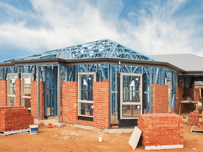 New residential construction home from brick with metal framing against a blue sky; real estate Australian generic suburban homes