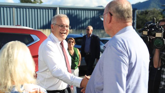 Prime Minister Scott Morrison shakes hands with Member for Leichhardt Warren Entsch at the Cairns and District Darts Association Hall. Picture: Brendan Radke