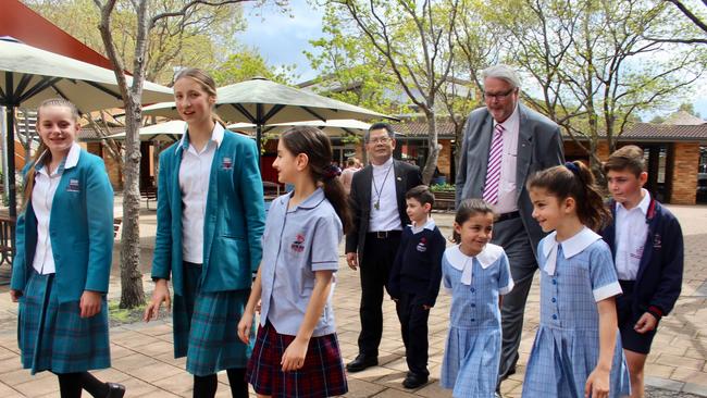 Parramatta Bishop, Vincent Long Van Nguyen and Catholic Education executive Greg Whitby at the site of the new Westmead mega school. L to R: Monique Turner, Aimee Hassett, Ella Baini, Jesse Hekeik, Sienna Mardini, Alessia Mardini and Christian Mardini.