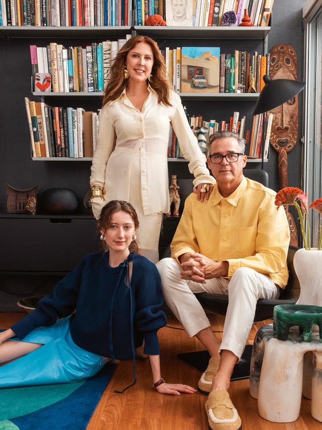 Clockwise from above, artists Camille Olsen-Ormandy, in <b>Gucci</b> jumper and skirt; <b>Louise Olsen X Alex and Trahanas</b> earrings; <b>Cartier</b> yellow gold and leather strap Tank Louis Cartier watch. Louise Olsen, in <b>Sportmax</b> shirt and skirt; <b>Louise Olsen</b> earrings, bracelets and rings; <b>Dinosaur Designs</b> ring and bangles; <b>Louise Olsen X Alex and Trahanas</b> bangle. Stephen Ormandy, in <b>Brunello Cucinelli</b> pants; <b>Hermès</b> shoes; his own jacket and glasses. Also shown at right, <b>Dinosaur Designs</b> Valley vase, Branch bowl and side table. In bookcase, <i>The Lair</i> (2022) by Camille Olsen-Ormandy. Picture: Michael Comninus