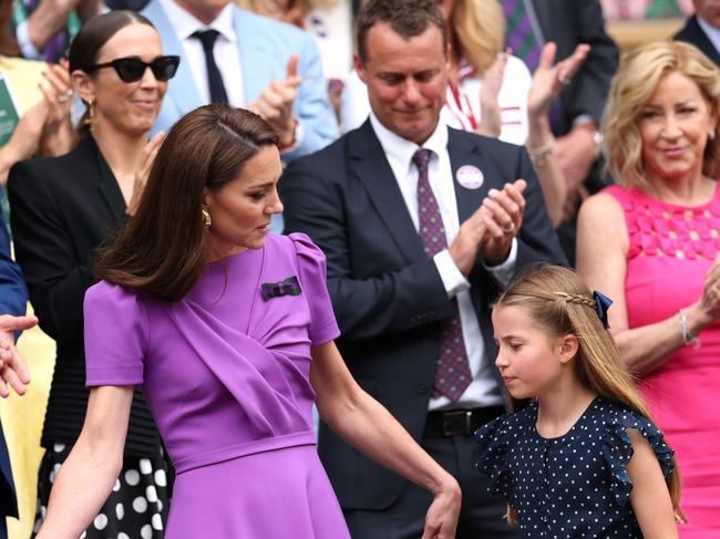 As always a doting mother, Kate guided Charlotte to her seat. Picture: Getty Images.