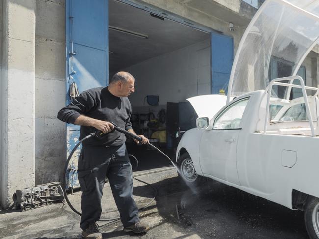 In this 29 April 2025, photo released by Caritas Jerusalem a man washes a popemobile donated by late Pope Francis before his death to be converted into a mobile health unit to serve the children of Gaza. (Caritas Jerusalem via AP)