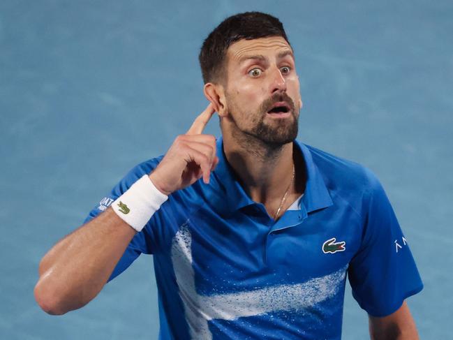 Serbia's Novak Djokovic gestures to the crowd after winning the third set during his men's singles quarterfinal match against Spain's Carlos Alcaraz on day ten of the Australian Open tennis tournament in Melbourne on January 21, 2025. (Photo by DAVID GRAY / AFP) / -- IMAGE RESTRICTED TO EDITORIAL USE - STRICTLY NO COMMERCIAL USE --