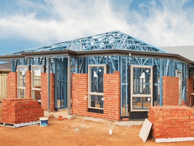 New residential construction home from brick with metal framing against a blue sky; real estate Australian generic suburban homes