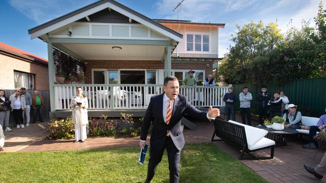 Auctioneer Damien Cooley calls bids at an auction in Sydney’s inner west, where the market has been heating up.