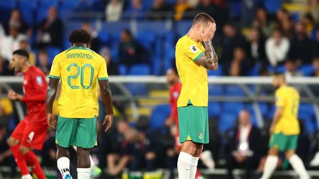 Substitutes Nestory Irankunda (left) and Mitchell Duke (right) are shattered after the Socceroos’ 1-0 loss to Bahrain. Picture: Chris Hyde/Getty Images