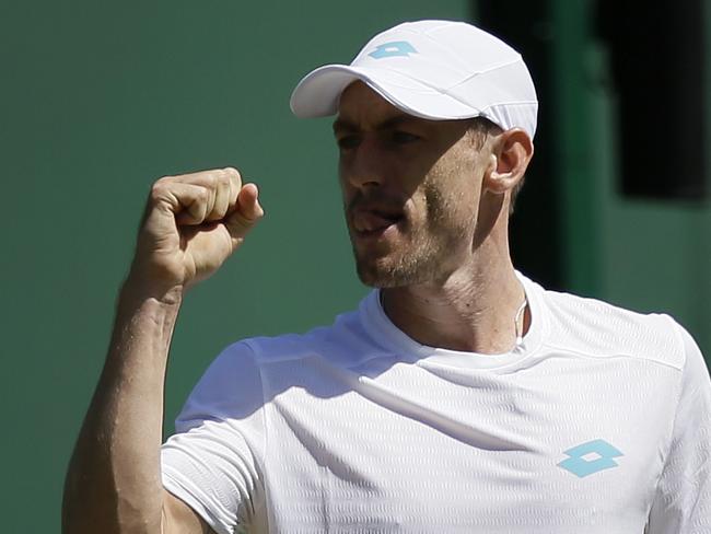 Australia's John Millman reacts after winning a point against Serbia's Laslo Djere in a Men's singles match during day four of the Wimbledon Tennis Championships in London, Thursday, July 4, 2019. (AP Photo/Tim Ireland)