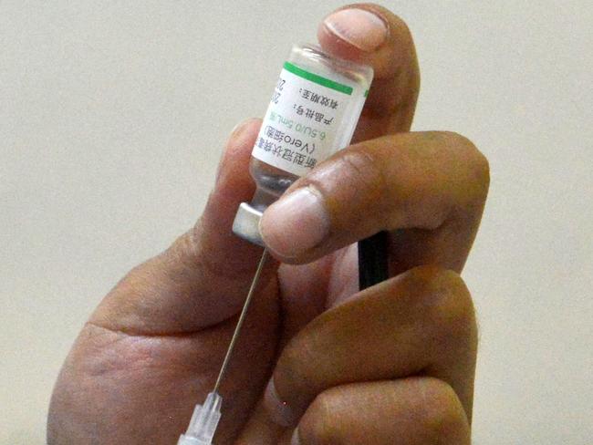 A health worker prepares a dose of the Covid-19 vaccine developed by China's Sinopharm company at the Hospital del Nino in La Paz on February 26, 2021. (Photo by AIZAR RALDES / AFP)