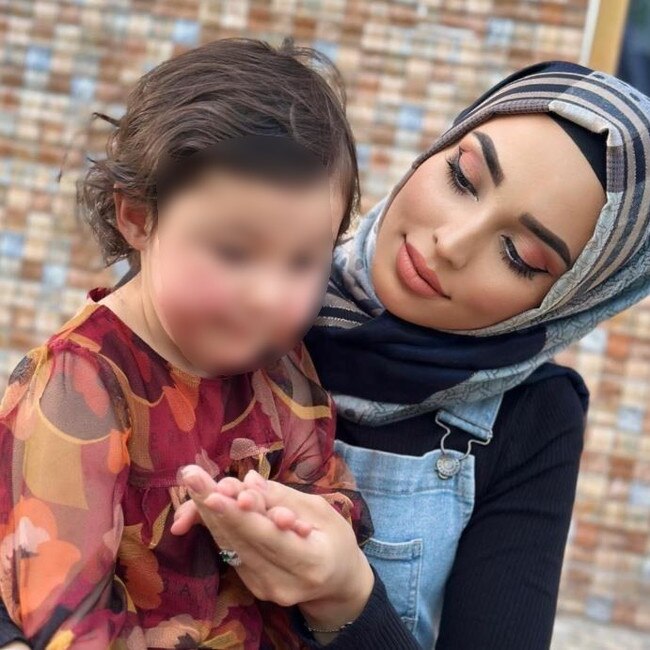 Muzhda Habibi, 23, with child