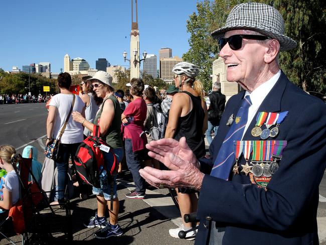 Ninety year old British Army veteran Robert Lamberth ,who is too old to march stands and applauds the marchers in Adelaide. Picture: Calum Robertson