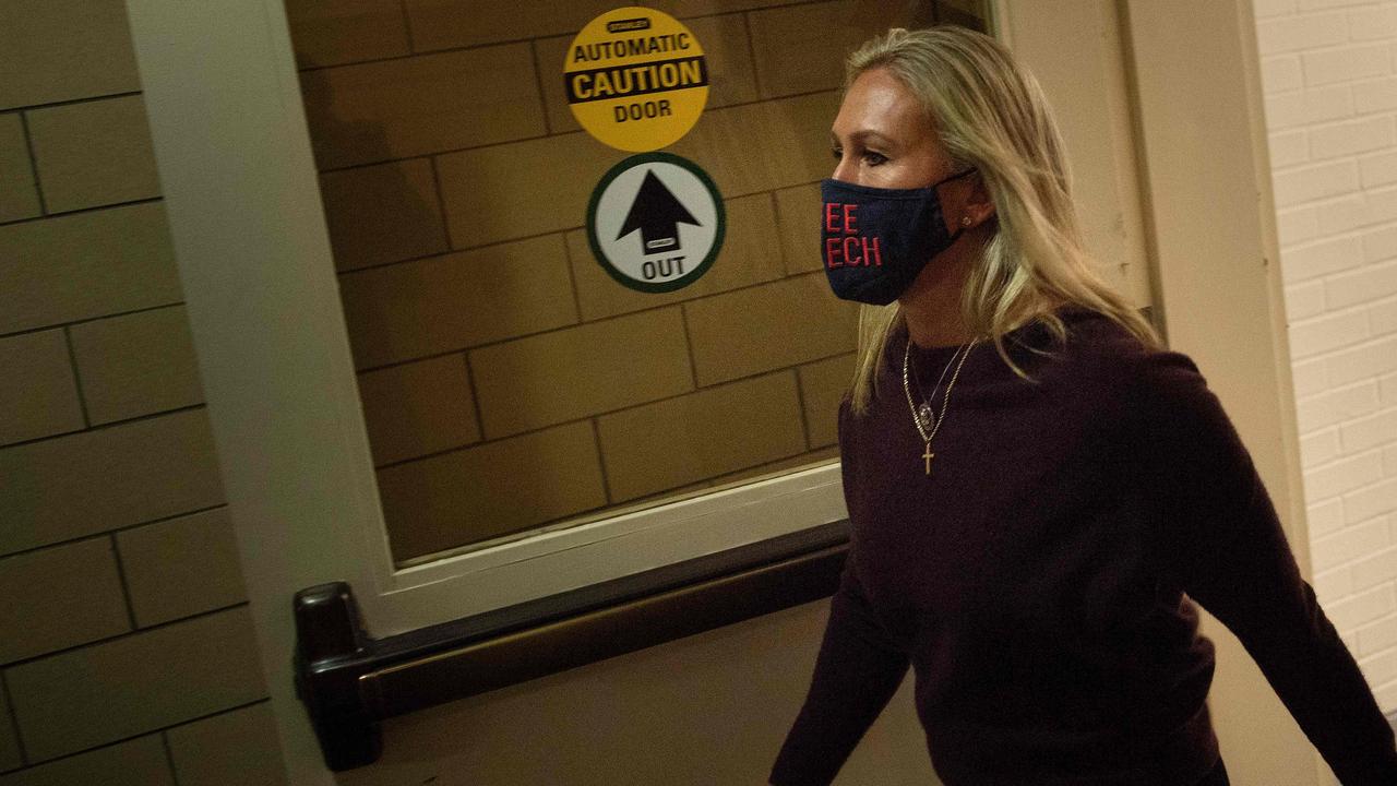 Ms Greene walking back to her office after speaking today. Her mask reads: “Free Speech” Picture: Brendan Smialowski/AFP