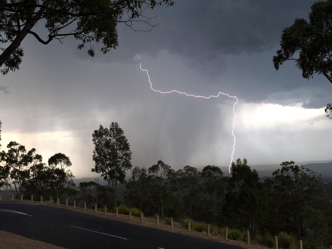 Lightning cracks as a large thunder storm moves in on Brisbane from the west, Monday, Oct. 27, 2014. The storm produced 5-10mm of rain. (AAP Image/Dan Peled) NO ARCHIVING