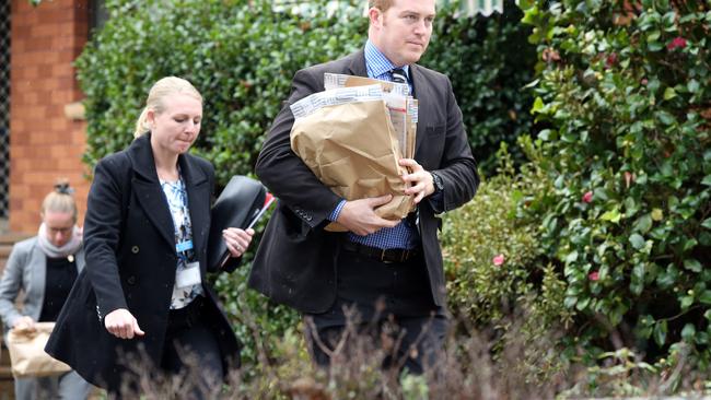 Detectives remove items. Picture: Richard Dobson