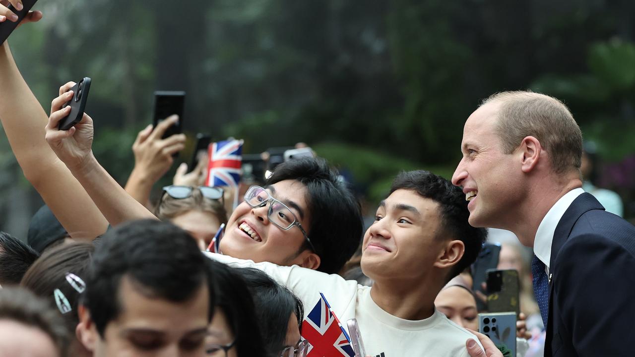 Prince William happily posed for selfies with fans during his visit to the HSBC Rain Vortex at Jewel Changi Airport. Picture: Getty Images