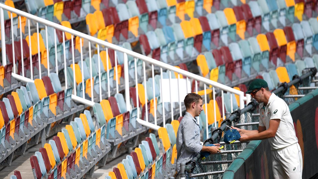 Josh Hazlewood signs an autograph for a lone fan at the Gabba.