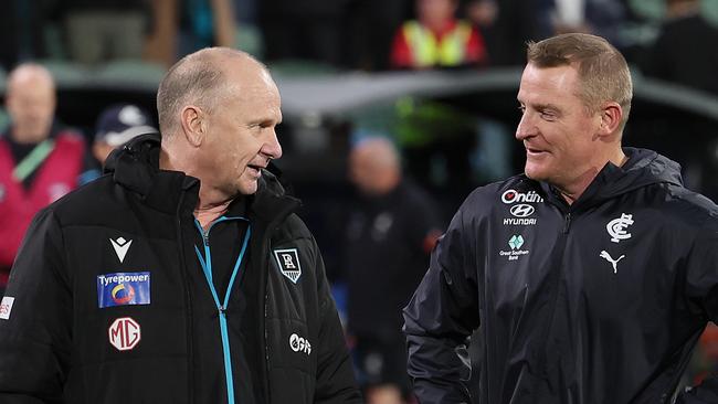 ADELAIDE, AUSTRALIA - MAY 30: Ken Hinkley, Senior Coach of the Power talks to Michael Voss, Senior Coach of the Blues during the 2024 AFL Round 12 match between the Port Adelaide Power and the Carlton Blues at Adelaide Oval on May 30, 2024 in Adelaide, Australia. (Photo by James Elsby/AFL Photos via Getty Images)