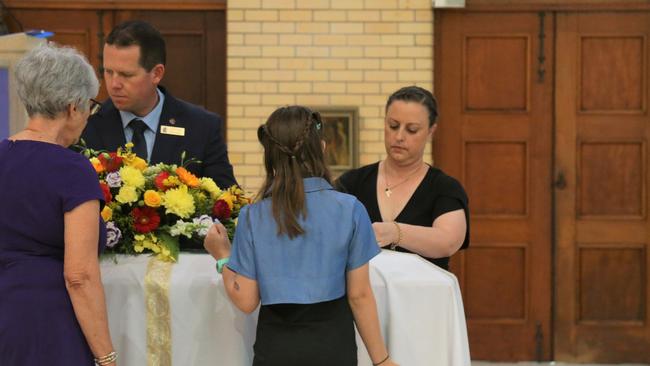 Linda Calanna, with Catherine and Madeline Hackett lay the pall over the casket of Mario Calanna's at a funeral service held on Tuesday at Saint Monica's Cathedral. Picture: Peter Carruthers